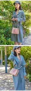 Fashionable plaid contrast chain crossbody bag styled with a blue trench coat