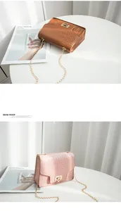 Detail showing stone pattern texture and gold chain strap of two fashion crossbody bags