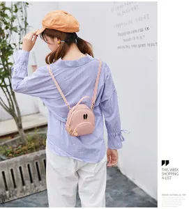 Back view of model wearing a stylish pink mini backpack with bunny ear hardware detail