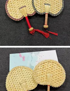 Detail shot of hand-woven natural straw fans featuring traditional Chinese craft details