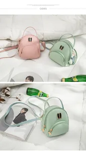 Detail view of mint green mini backpack with cute rabbit ears metallic accents