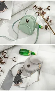 Detailed view of mini backpack purses in mint green and light gray shades with cute rabbit ears