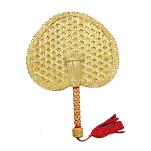 Traditional Chinese hand-woven natural straw cooling fan with a decorative red tassel