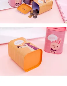 Close-up detail of cute cartoon animal metal tinplate piggy bank with coin slot lid