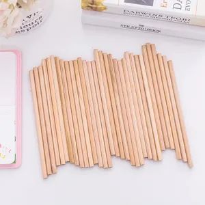 Macro view of sustainable raw wood HB pencils arranged neatly on a minimalist desk