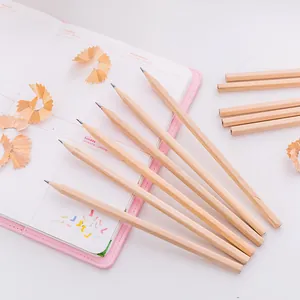 Close-up of sharpened natural wood HB pencils on a pink notebook with pencil shavings.