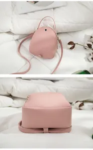Detailed view of the pink mini backpack and its flat base design