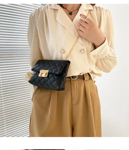 Elegant black quilted crossbody bag with gold chain strap and twist lock worn by model
