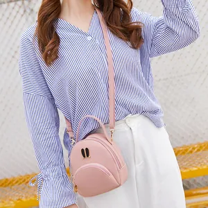 Fashionable pink mini crossbody bag with cute rabbit ear hardware decoration for girls