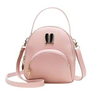 Cute light pink leather mini backpack and crossbody bag with bunny ears decoration