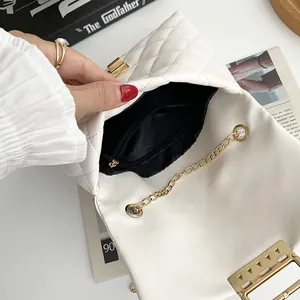 Interior view of white quilted chain bag with gold lock