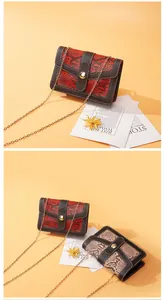 Detailed view of fashionable snake pattern crossbody bag with gold chain strap