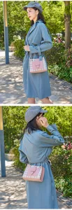 Asian model outdoors wearing a plaid color-block crossbody bag with golden chain strap