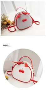 Detailed view of litchi grain crossbody bags with 3D cherry and ribbon bow decorations