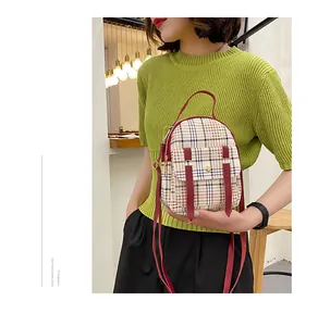 Stylish plaid mini backpack for women with red straps and top handle, detail view