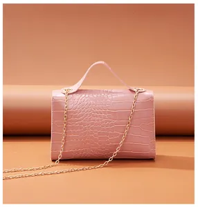 Detailed view of pink stone texture crossbody bag with elegant golden chain strap