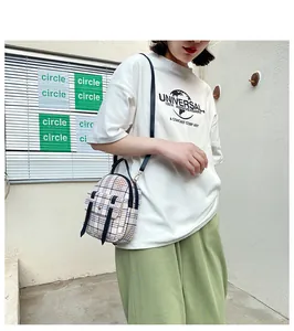 Detailed view showing a fashion checkered mini backpack worn as a stylish crossbody bag