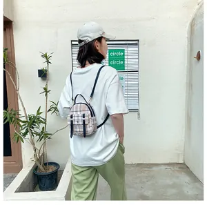 Stylish plaid mini backpack for women showcased in a casual outdoor lifestyle setting
