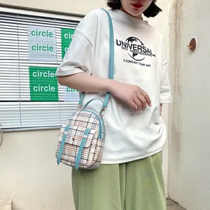 Fashionable plaid mini backpack crossbody phone bag for women with blue straps.