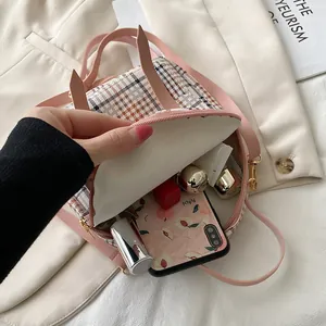 Stylish pink plaid mini backpack for women showing interior storage capacity for phones.