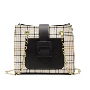 Stylish plaid crossbody bag with gold chain strap and black contrast details.