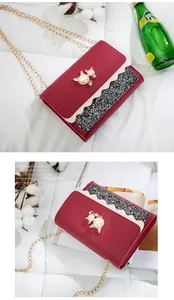 Red cat pearl chain bag detail showing the glitter panel and gold chain strap