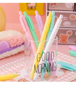 Close-up of pastel macaron retractable gel pens set in a stylish glass pen holder