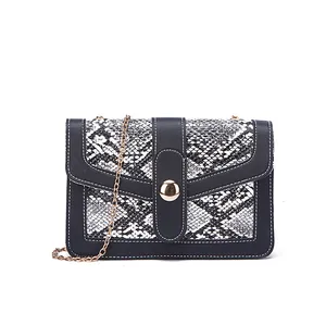 Chic snakeskin print small crossbody bag with gold chain strap and black leather trim