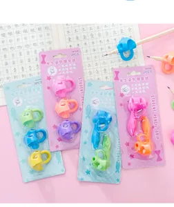 Detailed view of colorful silicone pencil grips in blister packs for handwriting training
