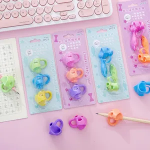 Ergonomic pencil grip posture corrector for kids and students in colorful blister packs