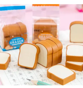 Nahaufnahme von kreativen Radiergummis in Toastbrotform auf einer Schulheftseite