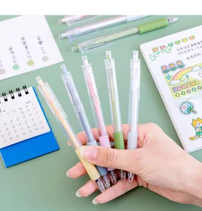 Close-up detail of a hand holding several pastel colored retractable gel pens with 0.5mm tips