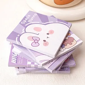 Detailed macro shot of cute purple Space Bunny cartoon sticky note pads stack view