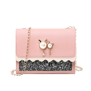 Elegant pink crossbody chain bag with pearl cat decoration and sparkly glitter panel