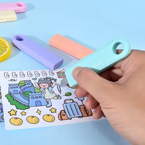 Close-up of a mini pastel utility knife being used for precise paper cutting