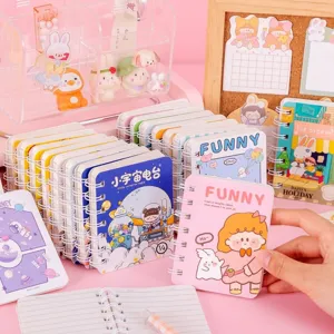 Close-up detail of colorful mini spiral notebooks featuring cute cartoon cover designs