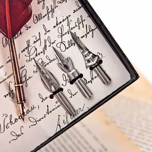 Detailed view of vintage silver metal fountain pen nibs and red quill feather pen