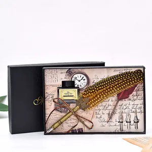 Detailed view of luxury vintage feather quill pen set with ink and nibs in gift box