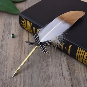Elegant vintage gold-dipped feather ballpoint pen with a black striped bow tie