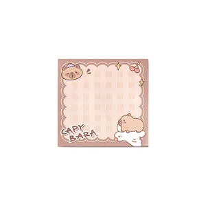 Cute cartoon capybara sticky note pad with grid pattern and brown scalloped border