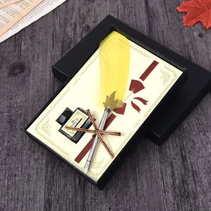 Vintage yellow feather quill pen and ink set in an elegant black gift box presentation