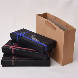 Elegant feather dipping pen gift box sets stacked with a brown kraft paper gift bag