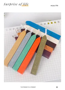 Close-up of vintage multi-color sealing wax sticks with embossed patterns and wicks