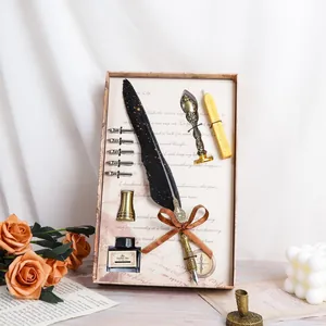 Vintage European quill pen gift set featuring black feather, ink, and wax seal stamp