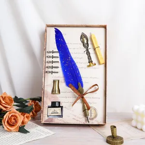 Vintage quill pen set with blue feather, ink bottle, and wax seal in gift box