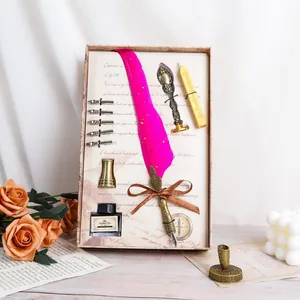 Elegant vintage pink quill pen set including ink bottle and wax seal in a decorative box