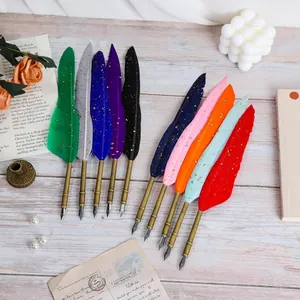 Vintage set of colorful feather dip pens with gold speckles and retro brass nibs