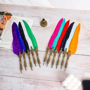 Detailed view of colorful retro European feather dip pens with ornate bronze nib holders