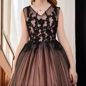 Detail of girls' black lace and pink tulle formal ball gown with v-neckline.