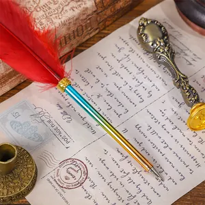 Vintage European style quill pen with red feather and blue-green gradient barrel